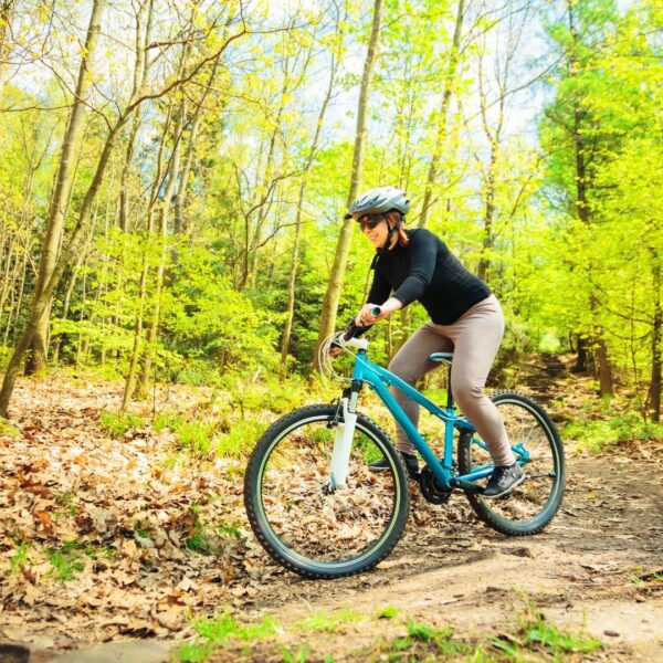 woman riding bike on trail